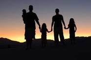 Picture of family backlit by a sunset